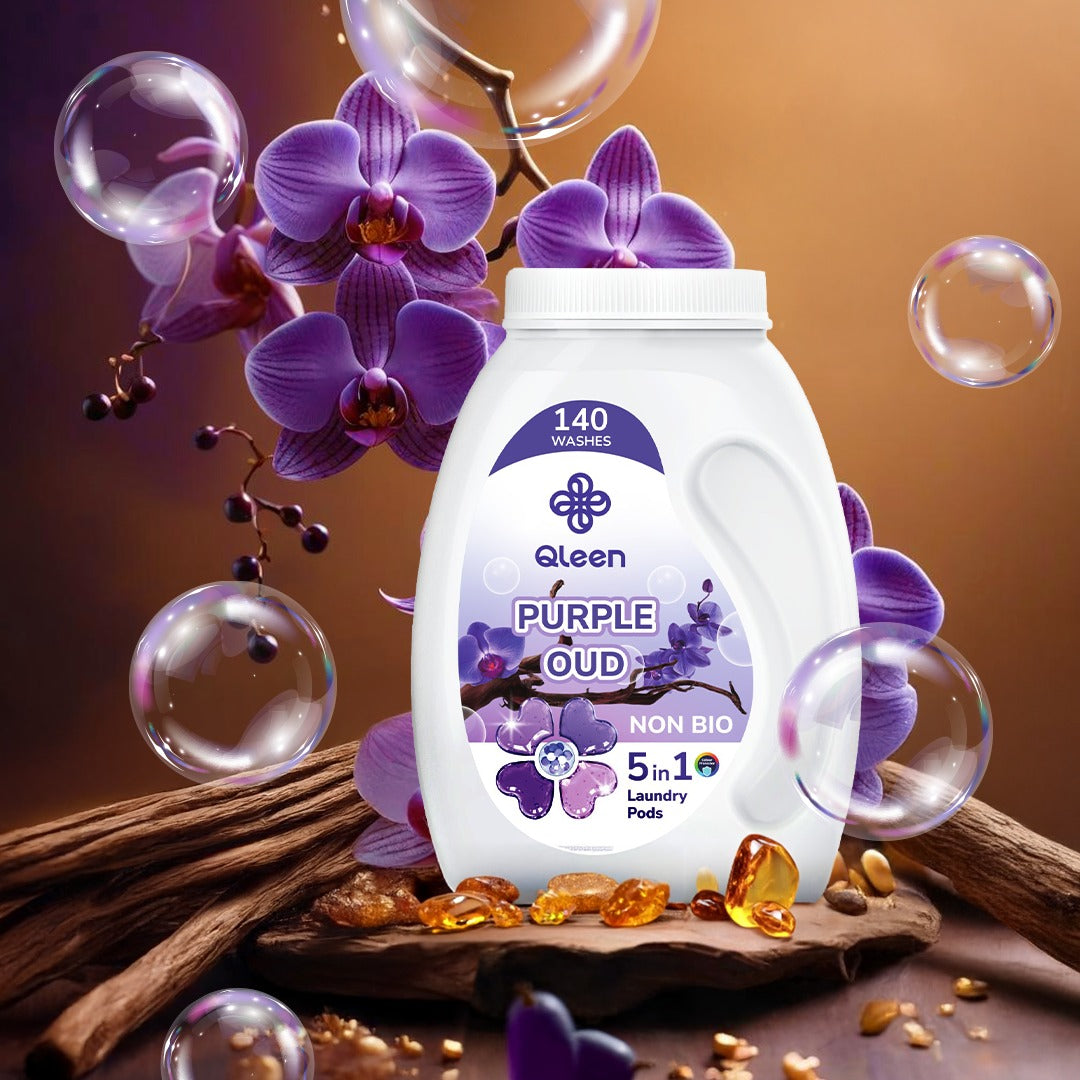 Qleen Purple Oud laundry pods with flowers and bubbles on a brown background